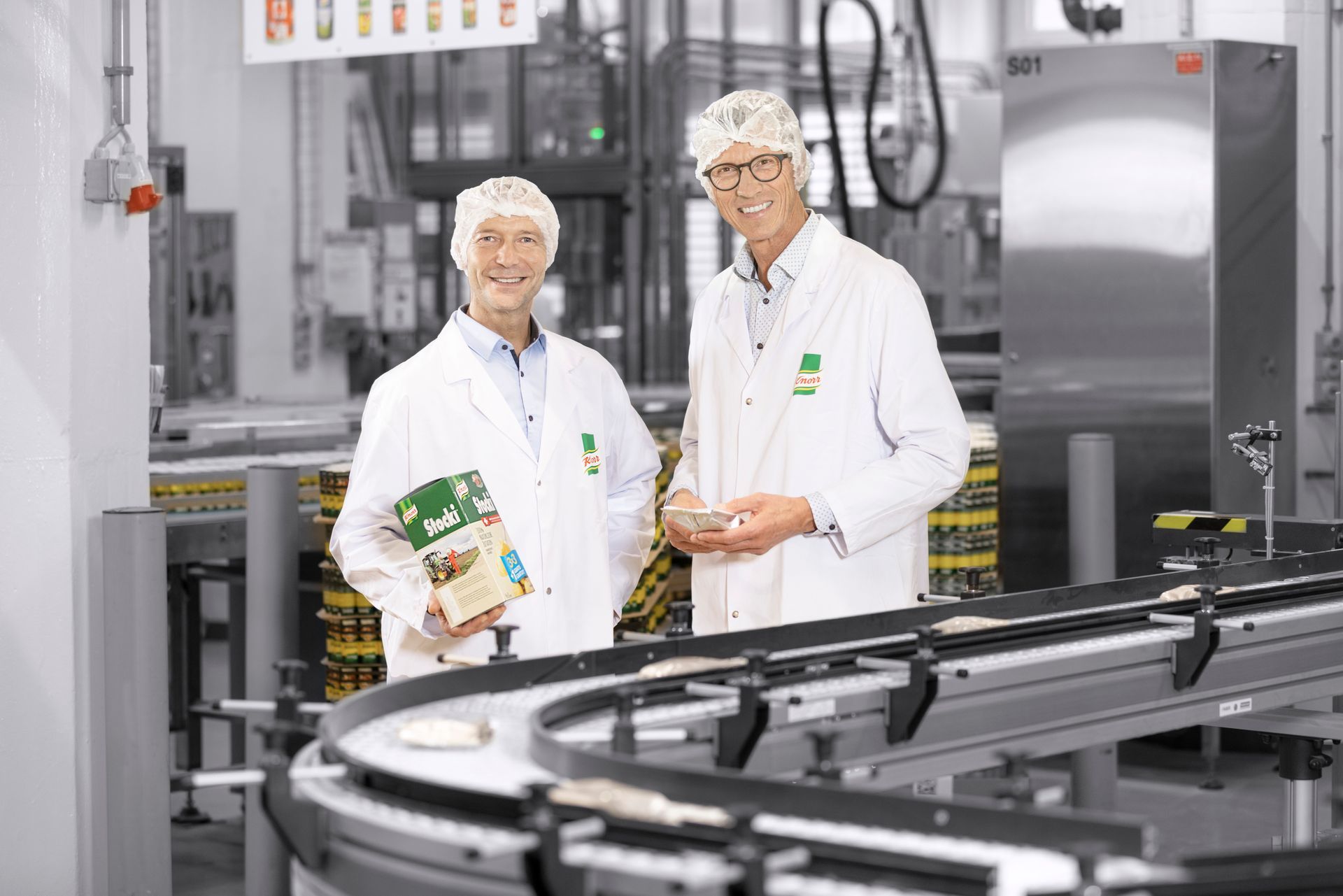Two men are standing next to each other in at Unilever, Thayngen, Schaffhausen, Switzerland.