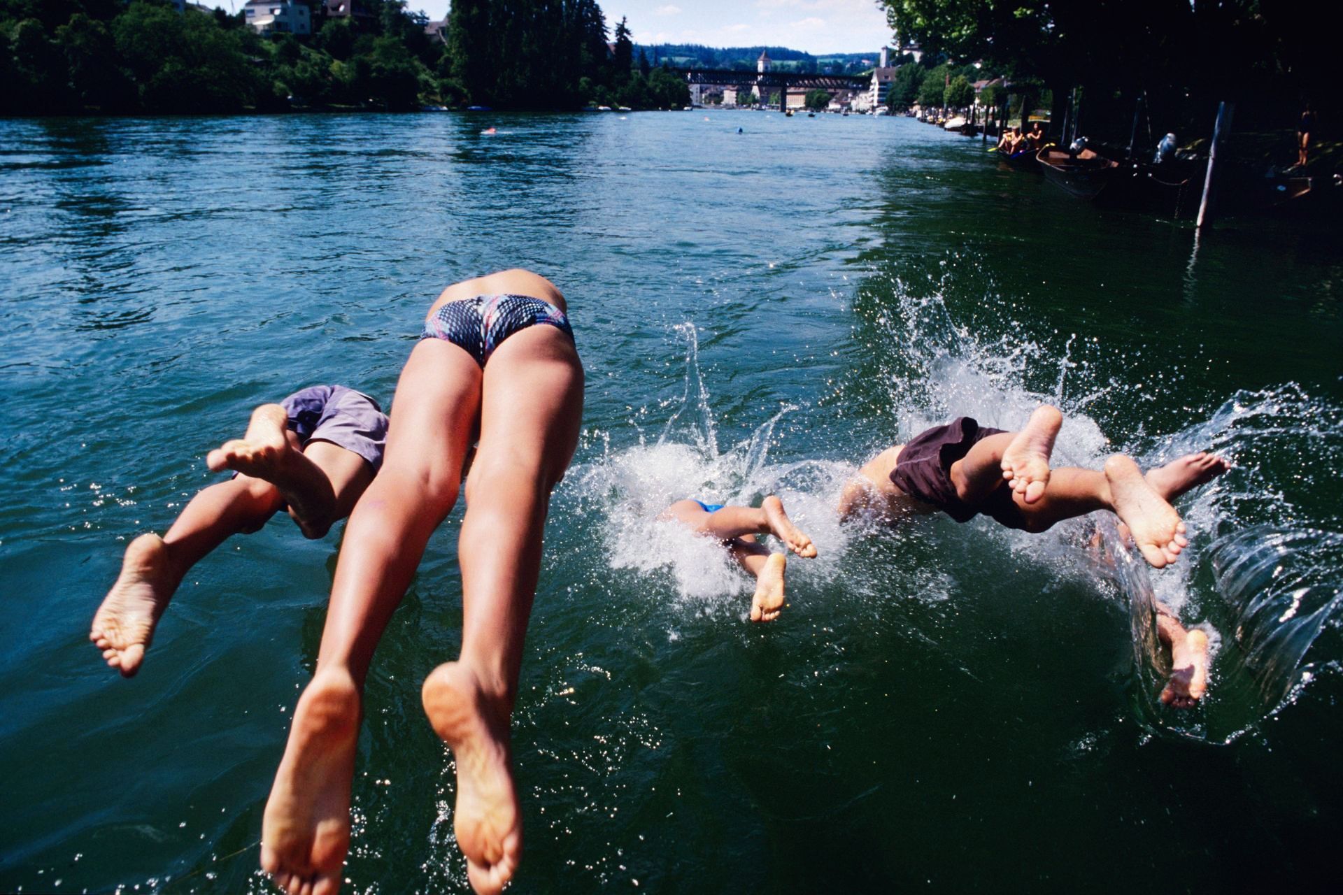 A group of men jumping into the rhine.